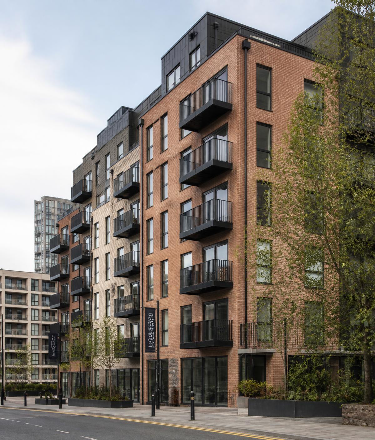 Modern UK city apartment building with brick and glass facade